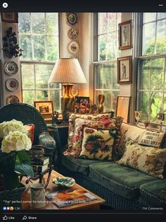 a living room filled with lots of furniture and windows covered in pictures on the walls