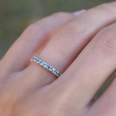 a woman's hand with a diamond ring on it