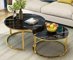 two tables sitting on top of a hard wood floor next to a couch and coffee table