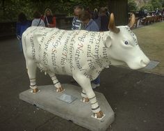 a statue of a cow with words written on it's body and two horns