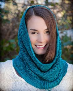 a woman wearing a blue knitted scarf