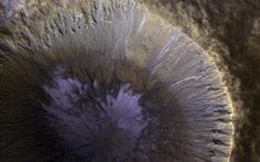 an aerial view of a crater in the middle of space, looking down on it's surface