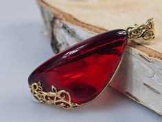 Welcome to handmade Baltic Amber jewelry shop. This Item is made of genuine, natural Amber. This item will make You look simple but gorgeous.  Length: ~ 2 x 5  cm , 8,89 gr weight. Luxury and royal, best gift idea for woman, wife, sister, mother...  Amber and gold jeweler.  Red very elegant Baltic Amber pendant. Handmade ruby red Amber jewelry. Gold plated sterling silver 925. High quality jewelry.  Our handmade jewelry is made with passion and love. If you have any problems with your order plea Handmade Baltic Amber Gold Necklaces, Handmade Baltic Amber Teardrop Jewelry, Cabochon Baltic Amber Necklace As Gift, Baltic Amber Cabochon Necklace For Gift, Amber Cabochon Necklace For Gift, Baltic Amber Gemstone Necklaces For Gifts, Baltic Amber Gemstone Necklace Gift, Handmade Baltic Amber Jewelry Gift, Handmade Baltic Amber Jewelry For Gifts