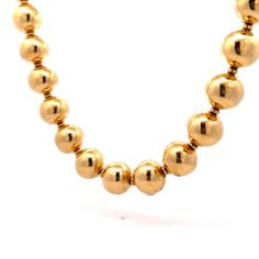 This modern beaded gold necklace creates quite the visual impact. Crafted from 18 karat yellow gold, the necklace is composed of hollow gold beads strung on a polished 18 karat yellow gold chain. The necklace is lightweight yet substantial, perfect for moments when the "WOW" factor is needed. The hollow gold beads have a high polished finish, making them glimmer and shine in the light. This necklace is the perfect blend of modern and classic, and a unique addition to any collection. Elegant Yellow Gold Beaded Necklaces With Round Beads, Classic Yellow Gold Beaded Necklace With Round Beads, Classic Yellow Gold Beaded Necklace, Luxury Gold Beaded Necklace With Polished Beads, Yellow Gold Beaded Necklaces For Formal Occasions, Elegant 14k Yellow Gold Beaded Necklace, Formal Yellow Gold Beaded Necklaces, Luxury Yellow Gold Necklaces With Gold Beads, Formal Gold Necklaces With Spacer Beads