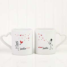 two white coffee mugs with the words, i love you written in red on them