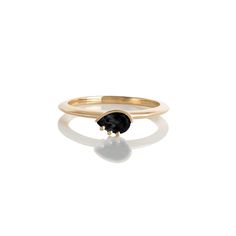 a gold ring with a black stone in the middle