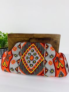 Ethnic clutch with seed beading on front side. Wooden handle 9 inches in length. Seed Beading, Beaded Clutch, Wooden Handles, Beading, Beads