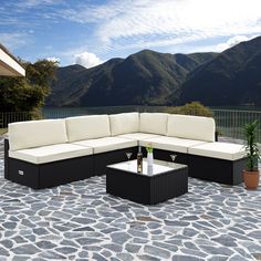 a black and white couch sitting on top of a stone patio