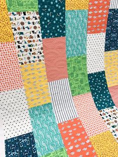 a patchwork quilt with different colors and patterns