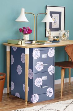 a blue desk with flowers painted on it