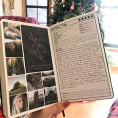 a person holding up a book with pictures on it in front of a christmas tree