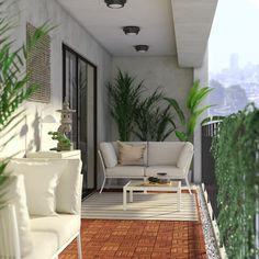 a white couch sitting on top of a wooden floor next to a plant filled wall