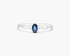 The 14K White Gold Infinity Sapphire Birthstone Ring is perfect for anyone looking for a stylish and elegant piece of jewelry. The ring features a delicate infinity band with a round brilliant cut sapphire in the center. The sapphire is a beautiful and rare gemstone that is prized for its vibrant color and brilliance. It is said to be a symbol of hope and commitment. The ring is a perfect gift for anyone who is born in September or who loves the color blue. It is also a great way to show your lo Elegant Adjustable Sapphire Ring With Birthstone, Elegant Adjustable Sapphire Birthstone Ring, Elegant Adjustable Ethical Sapphire Ring, Elegant Birthstone Stackable Rings, Adjustable Elegant Sterling Silver Sapphire Ring, Elegant Adjustable Birthstone Ring With Accent Stones, Elegant Infinity Jewelry With Accent Stones, Elegant Adjustable White Gold Sapphire Ring, Elegant Infinity Rings With Birthstone