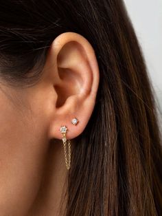 "A tiny flower stud embellished with brilliant cubic zirconia stones is attached to a dainty chain and butterfly back which drops down the front and connects behind the ear. Delicate with a little edge, these elegant earrings look beautiful layered with other dainty earrings. ∙ Sold individually (1 earring) or as a pair (2 earrings). * D E T A I L S * ∙ Material: .925 Sterling Silver or 18K Gold Plated over .925 Sterling Silver ∙ Stone: White Zirconia ∙ Dimensions: Flower: 5mm // Length: 2.7cm ∙ Tiny Gold Earrings, Tiny Gold Studs, Dainty Gold Earrings, Gold Chain Earrings, Front Back Earrings, Ear Jacket Earring, Dainty Studs, Tiny Studs, Tiny Stud Earrings