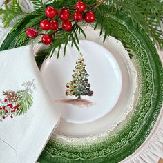 a white plate topped with a christmas tree on top of a green and white place mat