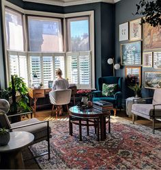 a living room filled with furniture and lots of windows