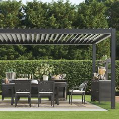 an outdoor dining area with table and chairs