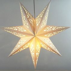 a white paper star hanging from a ceiling