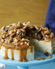 a piece of cake with nuts and caramel drizzled on the top