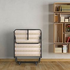 a chair sitting in front of a book shelf