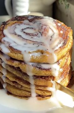 a stack of cinnamon rolls with icing on top