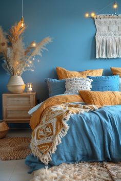 a bedroom with blue walls and yellow bedding, lights strung from the ceiling above