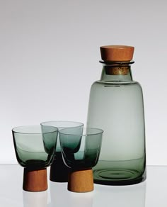 three glasses and a bottle on a table