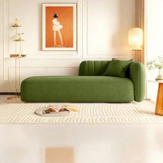 a living room with a green couch and white rug on the floor in front of a painting