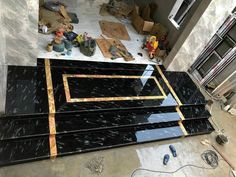 black marble flooring being installed in a room