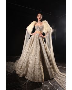 Ivory Lehenga Set - Bora Honey's Indulge in the allure of our Ivory Orave Lehenga, a bespoke creation designed to leave a lasting impression. Meticulously crafted over 60-90 days, this enchanting ensemble features a luxurious blend of ivory tulle and satin. The corset blouse with a corset neck beautifully accentuates your silhouette, while the shoulder trail adorned with feathers adds a touch of ethereal charm. Embellished with Swarovski crystals, sequins, cut-dana, and feathers, this lehenga is Indian Reception Outfit, Wedding Bride Dress, Ivory Lehenga, Indian Reception, Lehenga Bridal, Hand Embroidery Work, Indian Wedding Bride, Reception Outfit, Corset Blouse