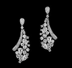 pair of diamond earrings on black background