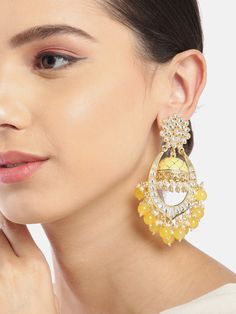 These beautiful yellow dome shaped jhumka earrings come with kundan stone studs & beads, are gold-plated and are secured with a post and back closure. These handcrafted jhumkas can be paired with any traditional outfit to add a punch of colorful boost, and help you stand out. Product color may vary based on the monitor or screen you are using.See FAQ for more details. Size Length: 9.5 cm Details Material: BrassStones: Kundan & Artificial BeadsPlating: Gold-plated Yellow Jhumka Earrings, Yellow Colour Earrings, Gold Jhumkas For Festive Occasion, Festive Kundan Beaded Earrings With Latkans, Festive Kundan Chandbali Beaded Earrings, Festive Kundan Beaded Chandbali Earrings, Gold Jhumkas With Latkans, Festive Bollywood Kundan Beaded Earrings, Gold Chandbalis With Cutdana