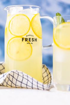 two pitchers of fresh lemonade next to each other