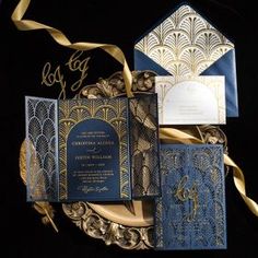 an elaborately designed wedding suite with blue and gold accents is displayed on a black background