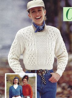 a woman wearing a white sweater and hat with her hands on her hips while standing next to another woman