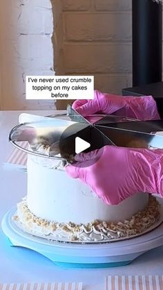 a person in pink gloves is cutting a cake