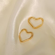 Fall in love with the playful elegance of Heart Hoops, beautifully crafted in 18k gold plating. These enchanting earrings feature a heart-shaped hoop design, perfect for adding a touch of romance and whimsy to any outfit. Trendy Gold Heart Earrings For Wedding, Gold Hypoallergenic Open Heart Hoop Earrings, Heart-shaped Yellow Gold Hoop Earrings For Everyday, Yellow Gold Heart Hoop Earrings For Everyday, Everyday Heart-shaped Hoop Earrings In Yellow Gold, Dainty Tarnish Resistant Hoop Earrings For Valentine's Day, Everyday Heart-shaped Yellow Gold Hoop Earrings, Everyday Heart-shaped Gold Plated Earrings, Gold Plated Hoop Earrings For Everyday And Valentine's Day