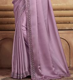 COLOR : Mauve FABRIC : Saree - Satin Silk, Blouse - Satin Silk & Net WORK : Resham Embroidery, Stones, Sequins, Lace BorderOCCASION : Wedding, Engagement, Party Wear, Festival, Sangeet NOTE : The outfit includes blouse and saree only. Petticoat is not included. READY-TO-WEAR : No STITCHING : Available as semi-stitched fabric, can be stitched using standard size option (+$30). Note: There might be a slight color variation due to lighting and flash used during photoshoot. The bright shade seen is Wedding Satin Blouse With Resham Embroidery, Elegant Purple Sets With Embroidered Border, Embroidered Satin Saree, Elegant Semi-stitched Purple Embroidered Fabric, Elegant Embroidered Satin Traditional Wear, Embroidered Satin Saree Set, Wedding Embroidered Satin Traditional Wear, Elegant Fitted Saree With Embroidered Border, Fitted Satin Dupatta With Embroidery