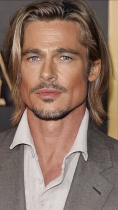 a close up of a person wearing a suit and tie with long hair on the red carpet