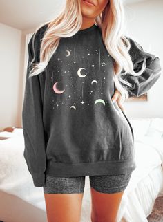 "Celestial Sweatshirt, Moon Sweatshirt, Moon Graphic Tee, Astrology Gift, Comfort Colors®, Garment Dyed, Oversized Boho, Vintage Celestial Hi! WELCOME TO DELUXSTOREUSA This sweatshirt perfect gift as a holiday apparel. Ideal for any situation, a unisex heavy blend crewneck sweatshirt is pure comfort  Washing Care Instructors Use cold water when washing, do not use bleach, do not dry clean, and do not use an iron directly on the design.  Production Time Production time is 1-2 days. Delivery time varies depending on your delivery address. How to Order?   Please, choose your favorite color and size from the pop-up window.  Select the quantity that you want.  Click \"ADD TO CART\".  You can go back to add more product color for your loved ones members.  You can complete the checkout process. Black Long Sleeve Top With Moon Print, Casual Crew Neck Top With Moon Print, Black Celestial Crew Neck Top, Long Sleeve Cotton Tops With Moon Print, Long Sleeve Cotton Top With Moon Print, Cotton Long Sleeve Tops With Moon Print, Celestial Crew Neck Top Relaxed Fit, Celestial Crew Neck Top With Relaxed Fit, Celestial Relaxed Fit Crew Neck Top