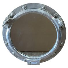 a metal porthole with rivets and screws on the side, isolated against a white background