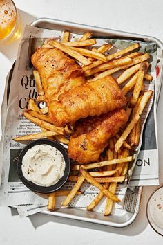 chicken and french fries in a tray with dipping sauce