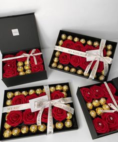 three black boxes filled with red roses and chocolates