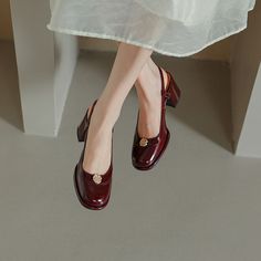 a woman's legs in high heels and a white dress