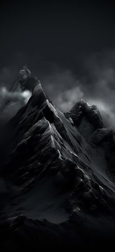 a black and white photo of the top of a mountain with clouds in the sky