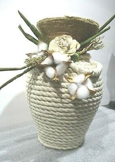 a white vase with some flowers in it