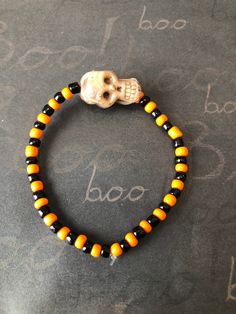 This is a Halloween Skull Beaded Bracelet. It would make a spooky addition to a Halloween costume. It would make a spooky gift for a teen or woman for Halloween. It has a large skull bead in the middle. It has orange and black seed beads. It was made with .8mm sturdy stretch string. I tie it several times to prevent breakage. It fits most teens and women. It stretches to fit on the wrist. All items are ready to be shipped I do combined shipping. Items ship in 2-3 business days. Check out more items at: http://www.etsy.com/shop/MesheleCrafts https://www.facebook.com/MesheleCrafts Orange Beaded Bracelets For Halloween, Handmade Beaded Bracelets For Halloween, Black Beaded Bracelet For Halloween, Black Beaded Stretch Bracelet For Halloween, Adjustable Black Beaded Bracelets For Halloween, Halloween Novelty Beaded Bracelets With Round Beads, Halloween Novelty Bracelet With Round Beads, Handmade Black Wristband For Halloween, Gothic Adjustable Bracelets For Halloween