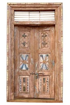 an old wooden door with decorative designs on the front and side panels, isolated against a white background