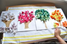 the paper flowers are cut out to make tree decorations for the kids's room