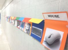 there is a mouse on the wall with pictures pinned to it